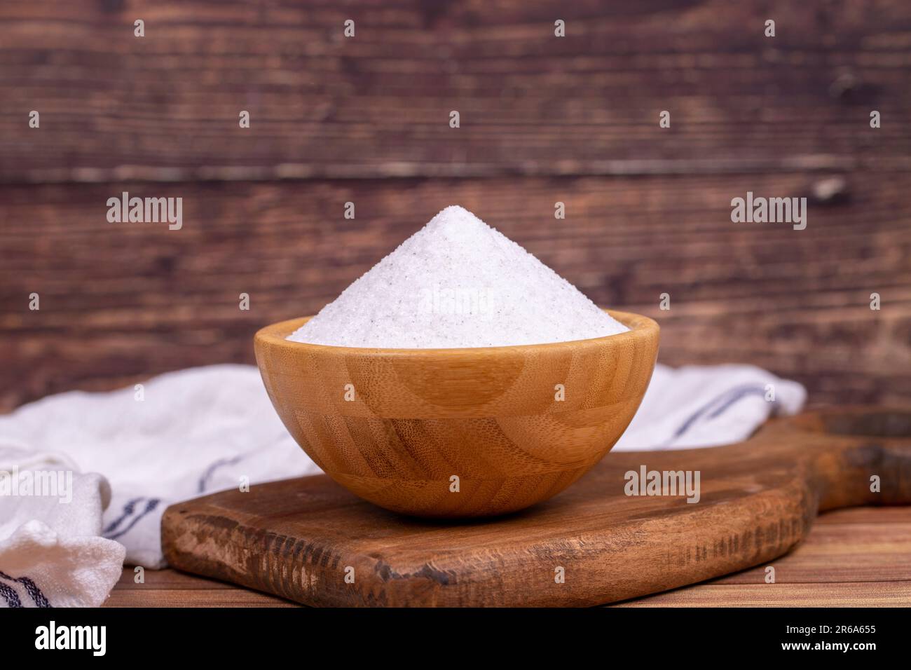 Natural minaret crystal non-iodized grinding salt on wooden background. Ground rock salt in wooden bowl Stock Photo