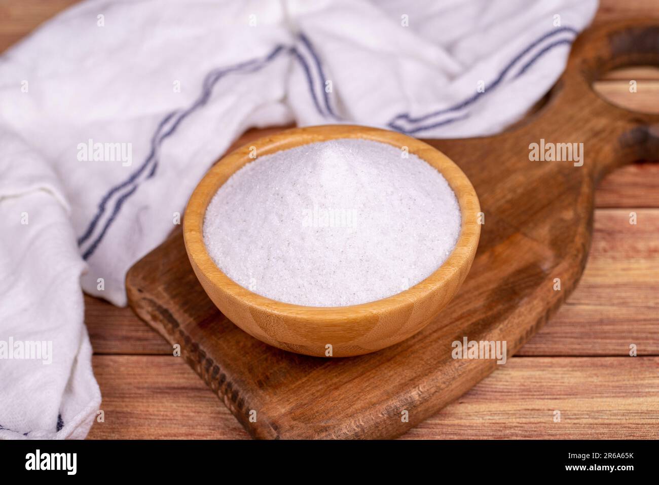 Natural minaret crystal non-iodized grinding salt on wooden background. Ground rock salt in wooden bowl Stock Photo