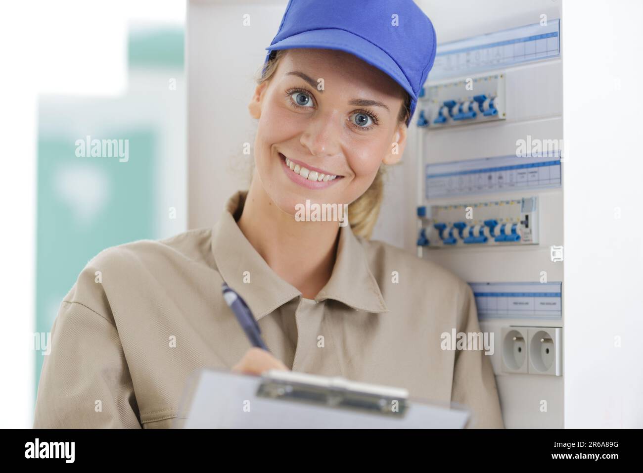 happy female technician electrical terminal box Stock Photo