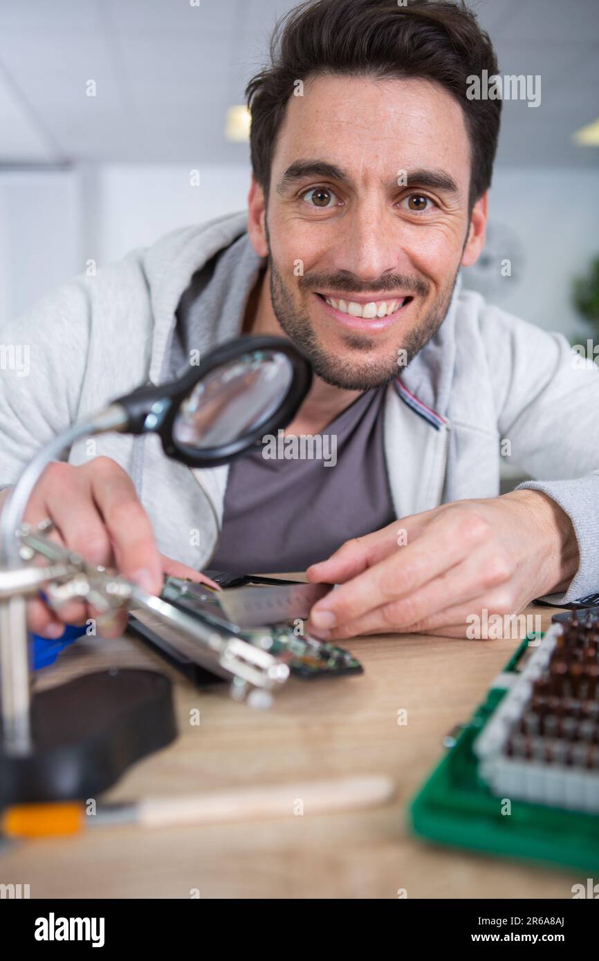 happy man with broken disassembled laptop Stock Photo