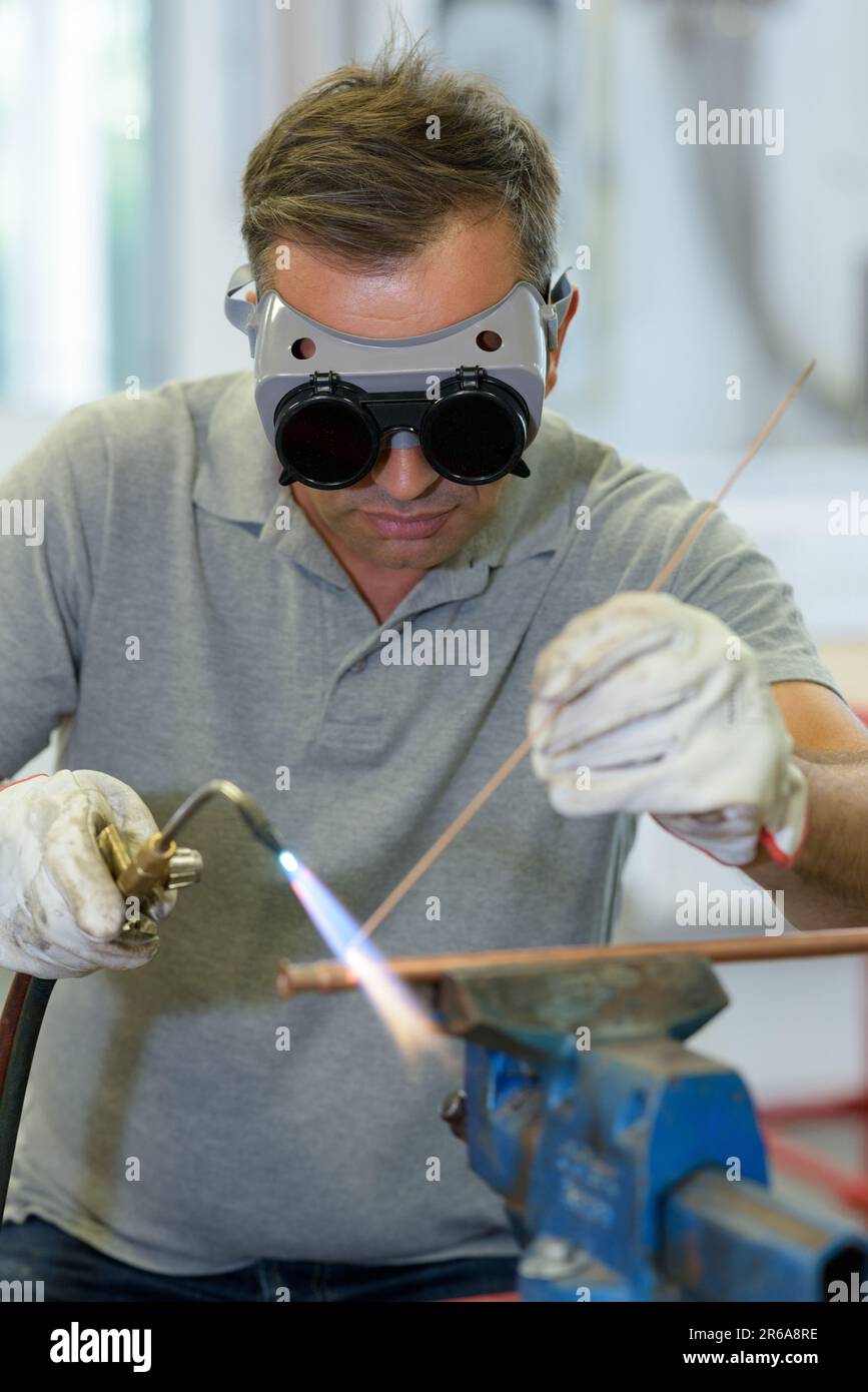 worker soldering a copper pipe with a blowtorch Stock Photo Alamy