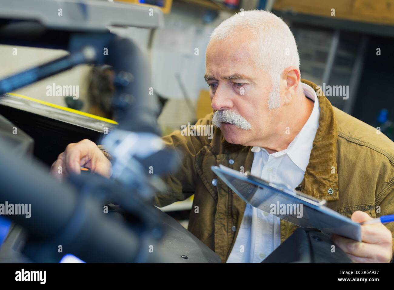 senior carpenter holding in his hand a blank clipboard Stock Photo - Alamy