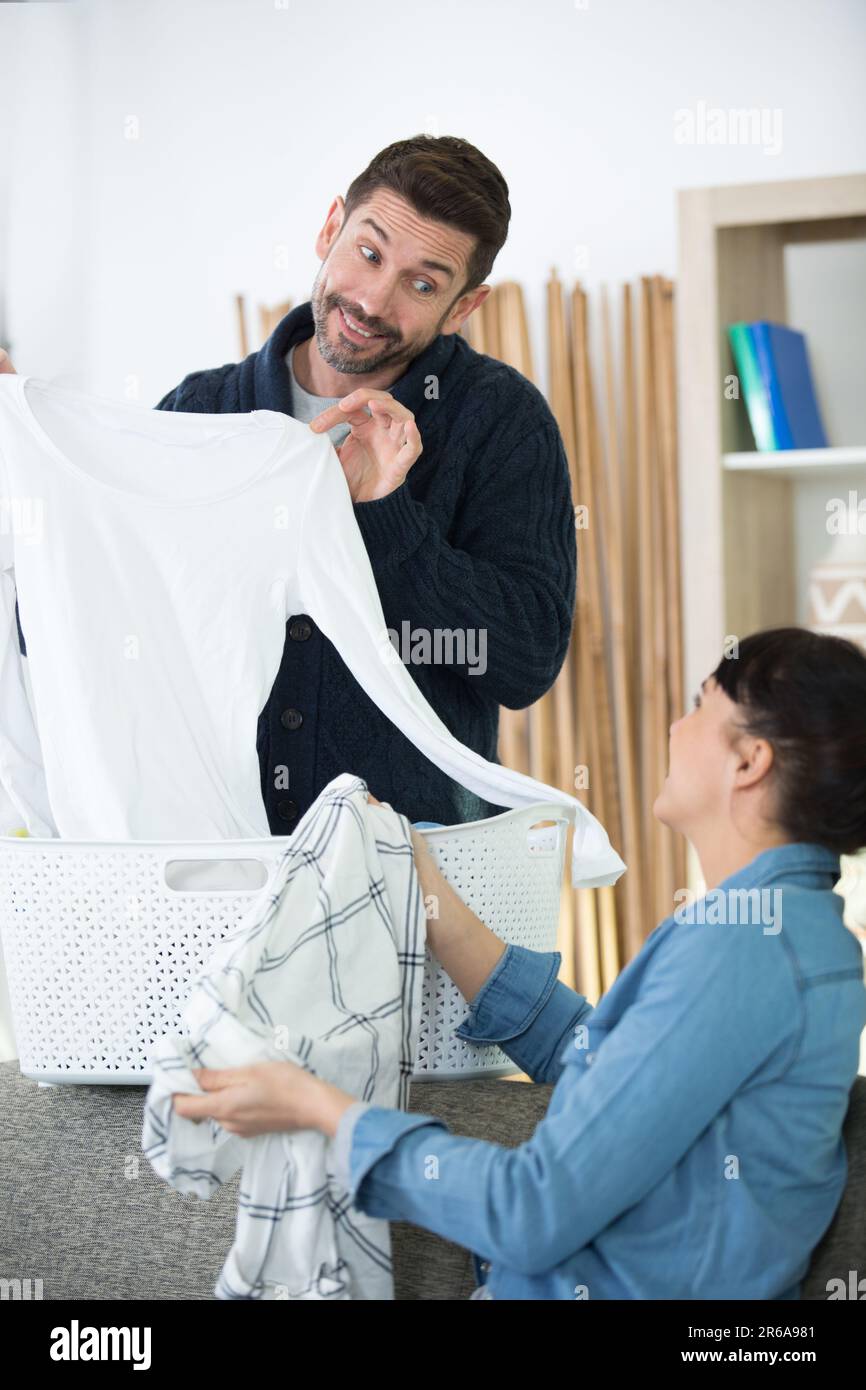 young happy couple doing their laundry together Stock Photo - Alamy