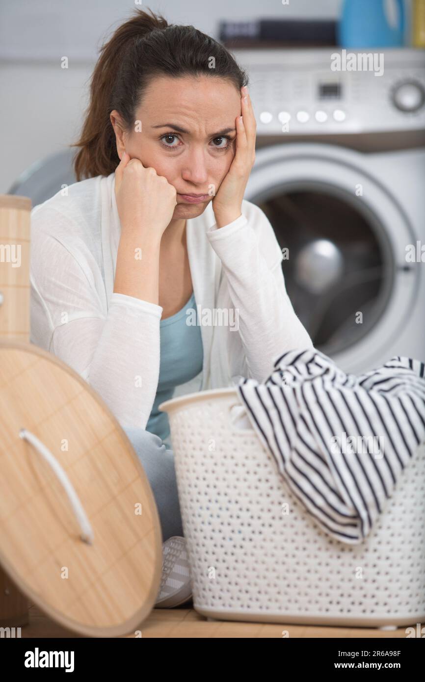 woman next to pile of dirty laundry Stock Photo Alamy