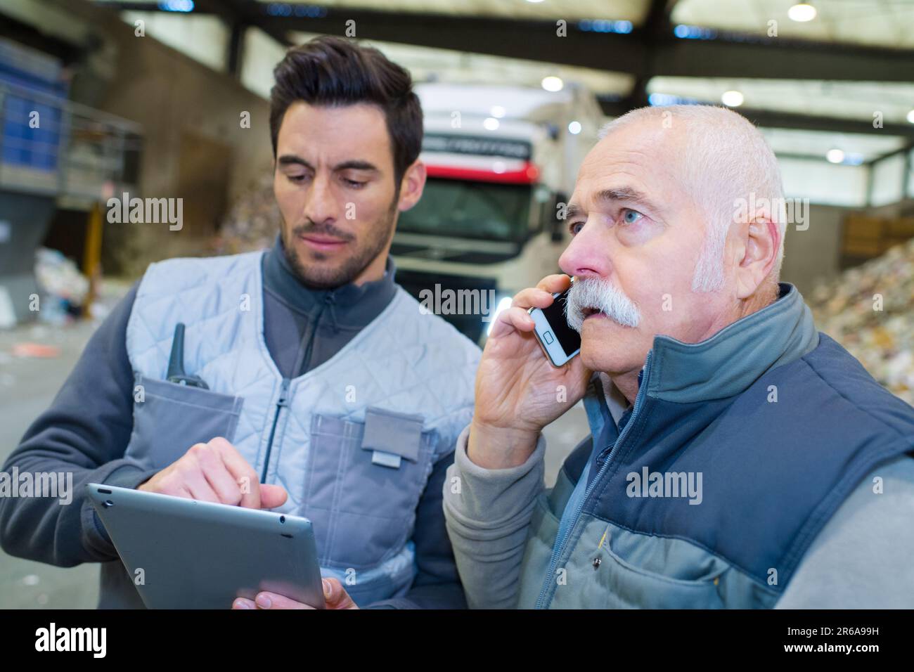 workers talking in recycling factory Stock Photo