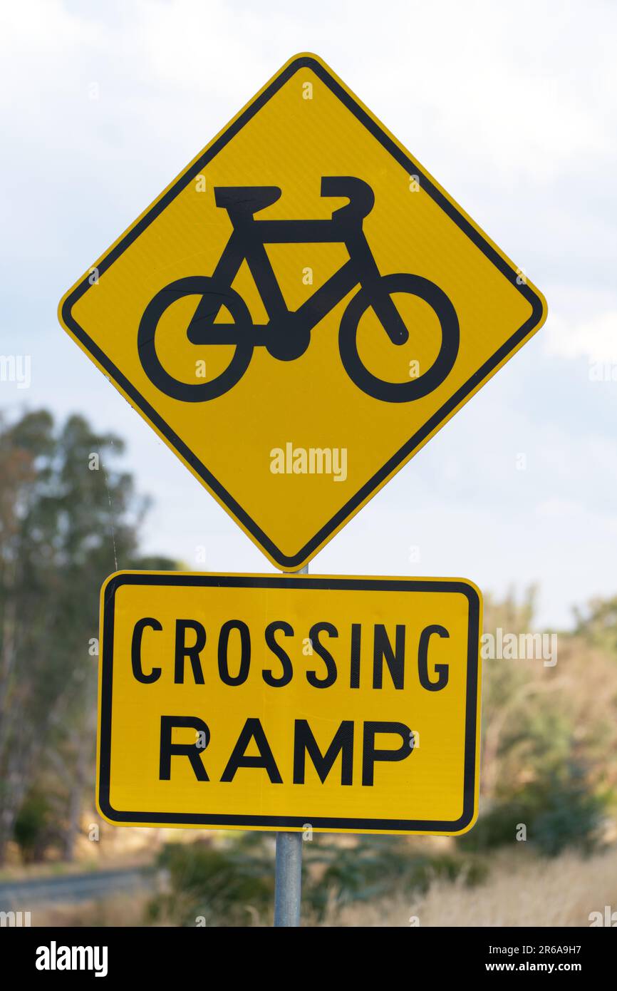 Bike warning sign and advisory sign showing bicycle symbol and crossing