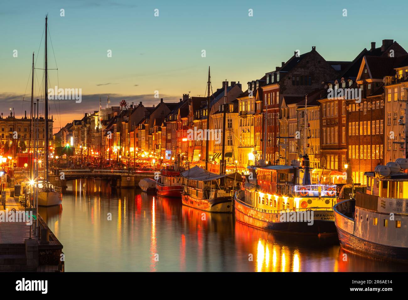 Denmark, Copenhagen - 15 May 2019: Nyhavn at night. A 17th-century waterfront, canal and entertainment district with brightly colored townhouses, bars Stock Photo