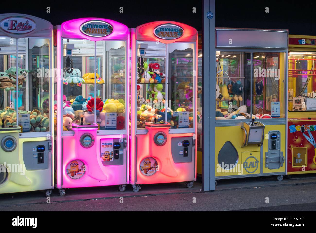 vienna, austria. 25 april 2023 the alluring array of colorful claw machines testing your skills to snag prizes with crane-attached claws in the penny Stock Photo