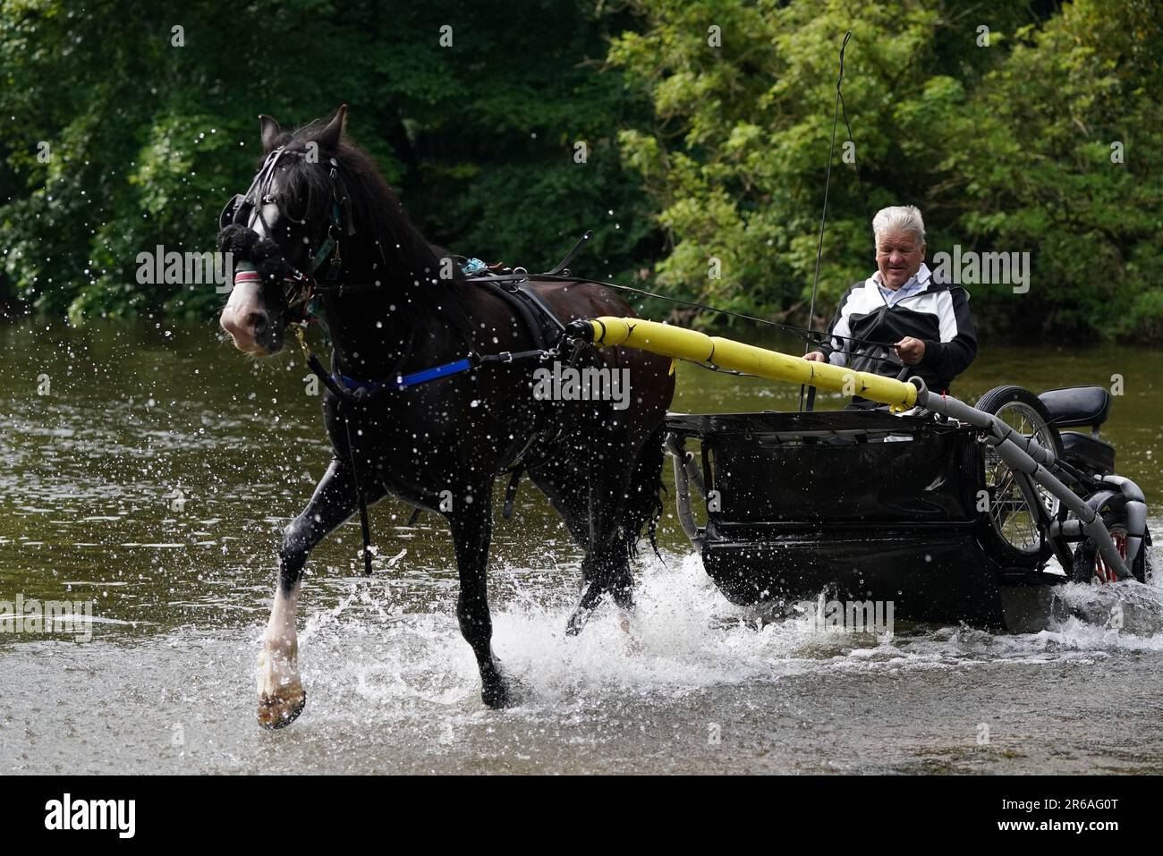A man rides his horse through the river during the Appleby Horse Fair, the annual gathering of