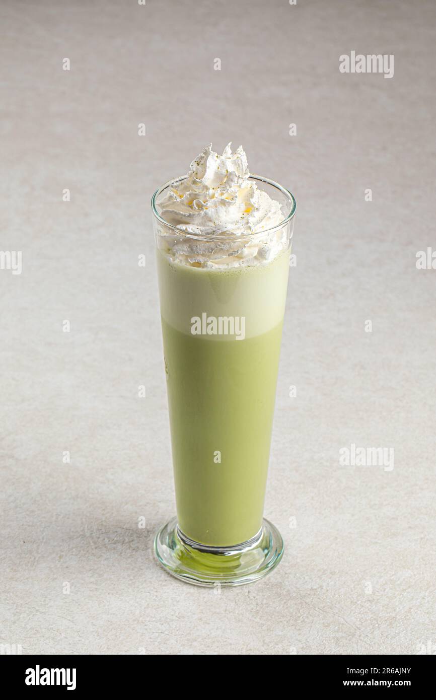 Portion of matcha latte with whipped cream Stock Photo
