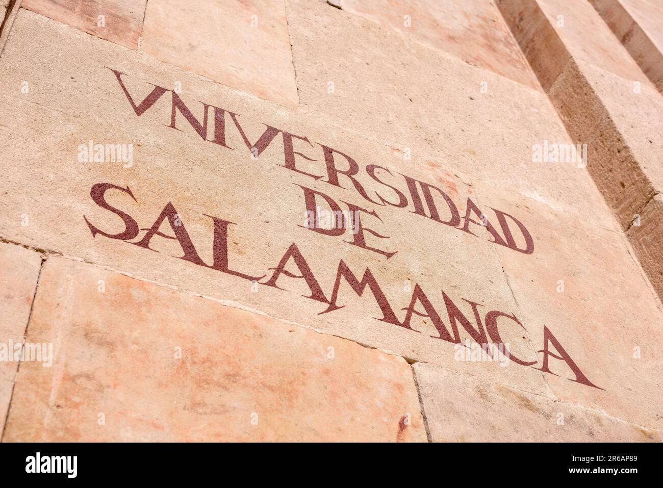 Salamanca University, view of the historic inscription sited on the characteristic pink sandstone wall of the university building in Salamanca, Spain Stock Photo