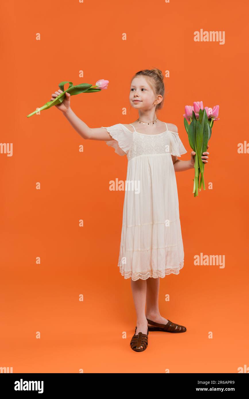 bouquet of flowers, preteen girl in white sun dress holding pink tulips ...