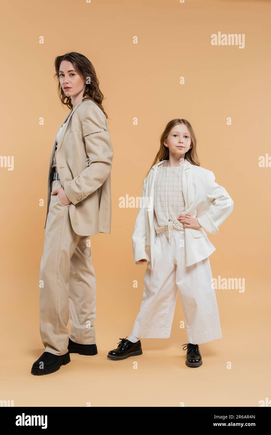 stylish mother child concept, woman in suit and preteen daughter
