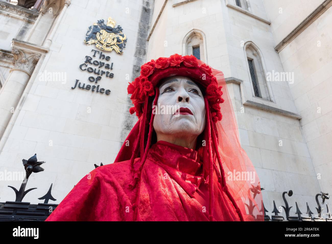 London, UK. 8 June, 2023. The Red Rebel Brigade mime troupe join opponents of a proposed scheme to drill for gas in Surrey rallying outside the Royal Courts of Justice at the start of a judicial review. The original application to search for fossil fuels in 2020 was rejected by Surrey County Council, but later approved by minister Michael Gove. Waverley Borough Council challenged this decision and were granted a judicial review. Arguments raised include greenhouse gas emissions and the proximity of the site to an Area of Outstanding Natural Beauty (AONB). Credit: Ron Fassbender/Alamy Live News Stock Photo