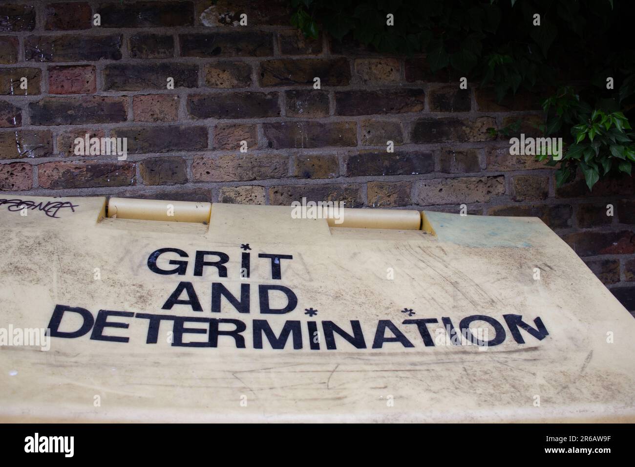 A local council roadside gritting bin, photographed in Haringey, London. After the word 'Grit' is added 'and determination' Stock Photo