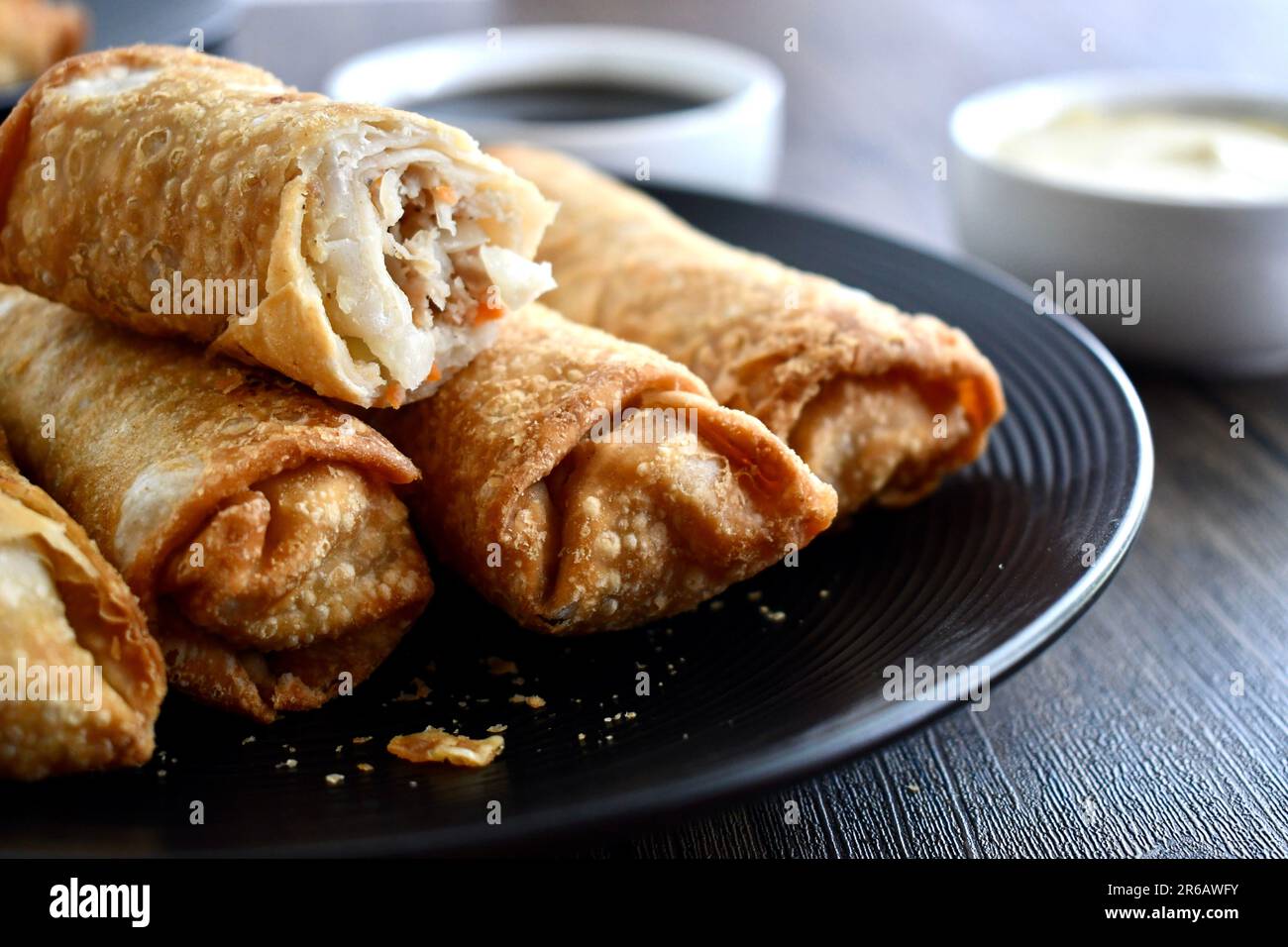 Egg rolls on a black plate Stock Photo