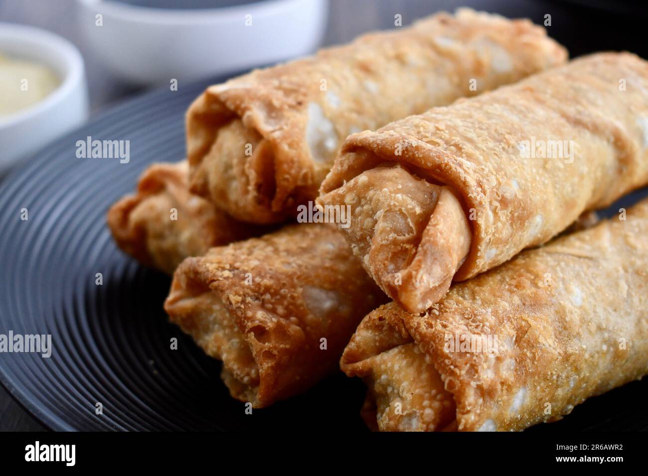 Egg rolls on a black plate Stock Photo