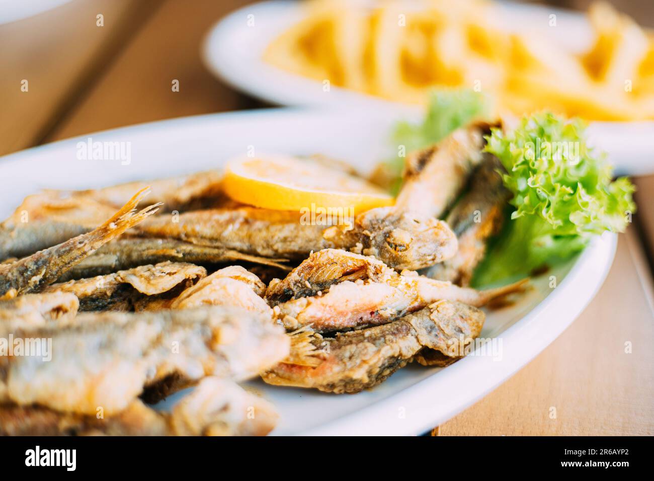 french fries and grilled fishes. fish and chips. Dish with Mullet Fish With orange. Fried fry