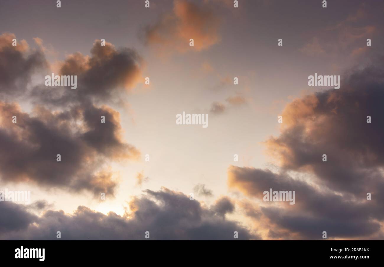 evening sky in orange glow. huge fluffy clouds. dramatic natural background Stock Photo