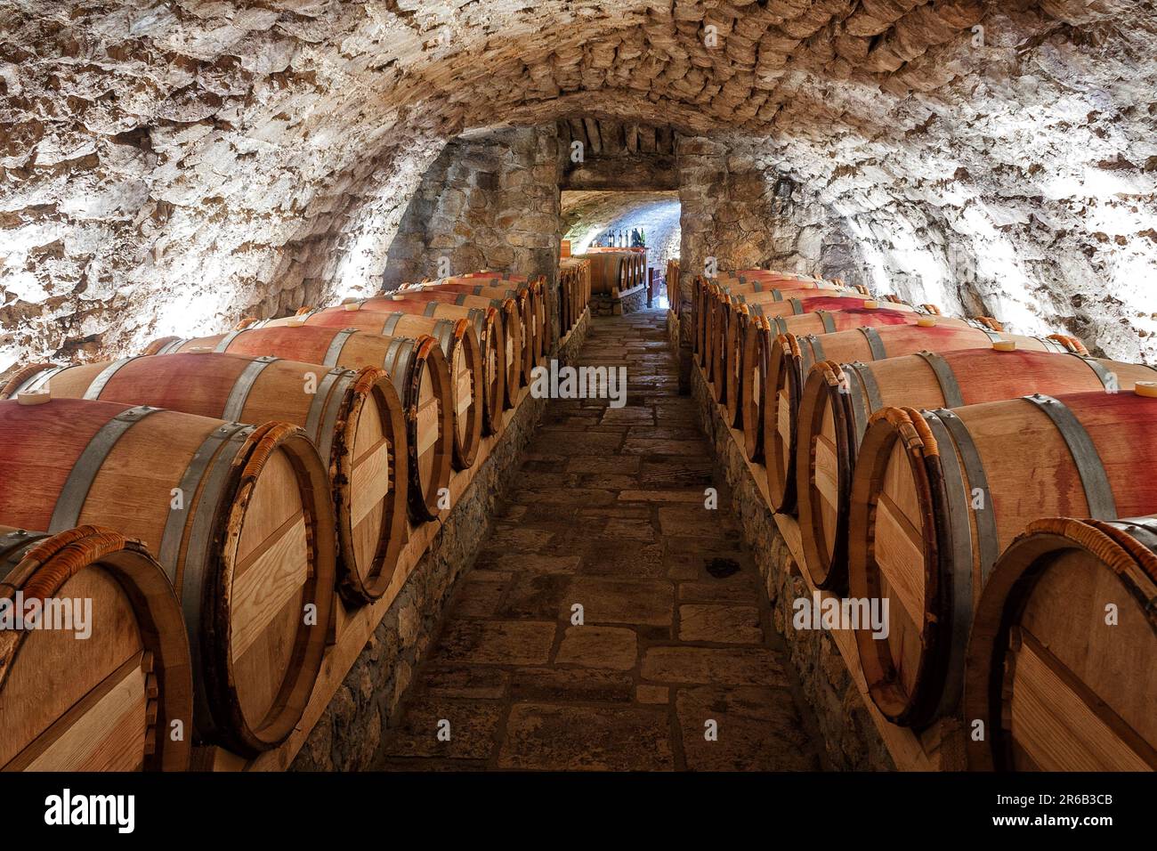 Wine cellar with row of wine barrels Stock Photo
