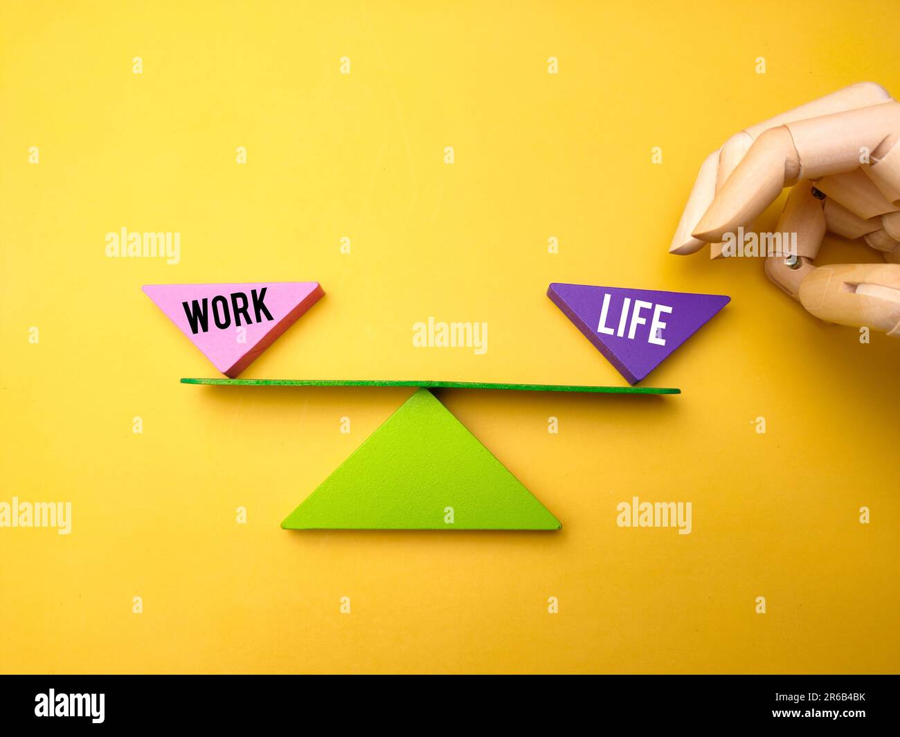 Two cubes crafted from wood, bearing the words Work and Life printed on ...