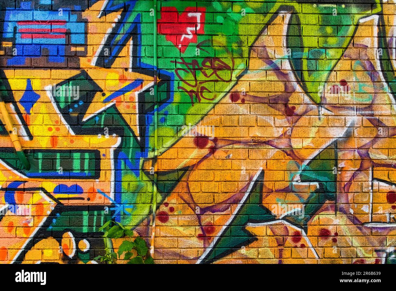 Toronto, Canada - June 4, 2023:  Kensington Market.  Colorful exterior wall art on a brick wall. No people are in the scene. Stock Photo