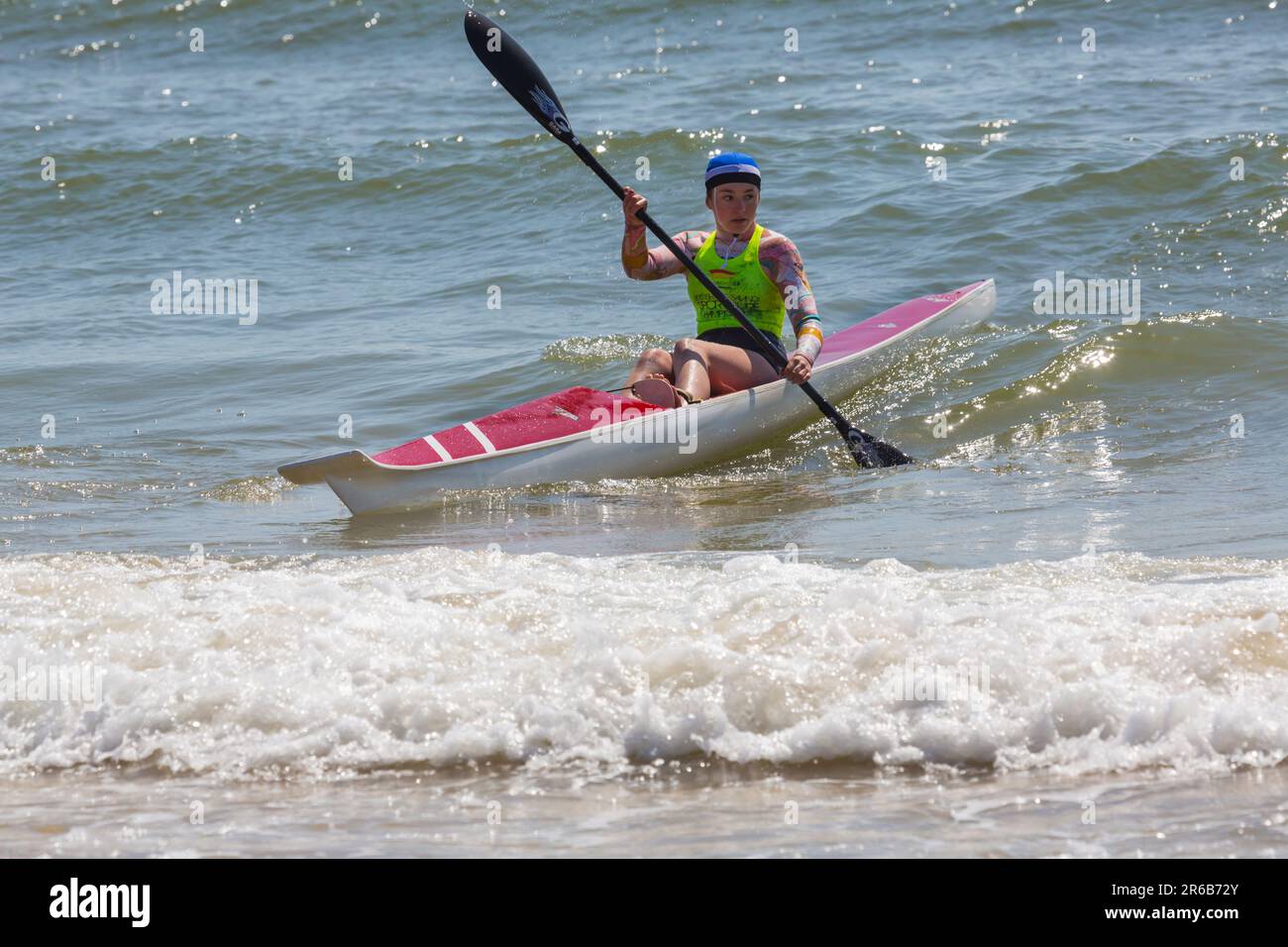Young woman in a surf ski surfski, the Surf Life Saving GB GBR Beach Trial Weekend at Branksome Chine, Poole, Dorset, England UK in June Stock Photo