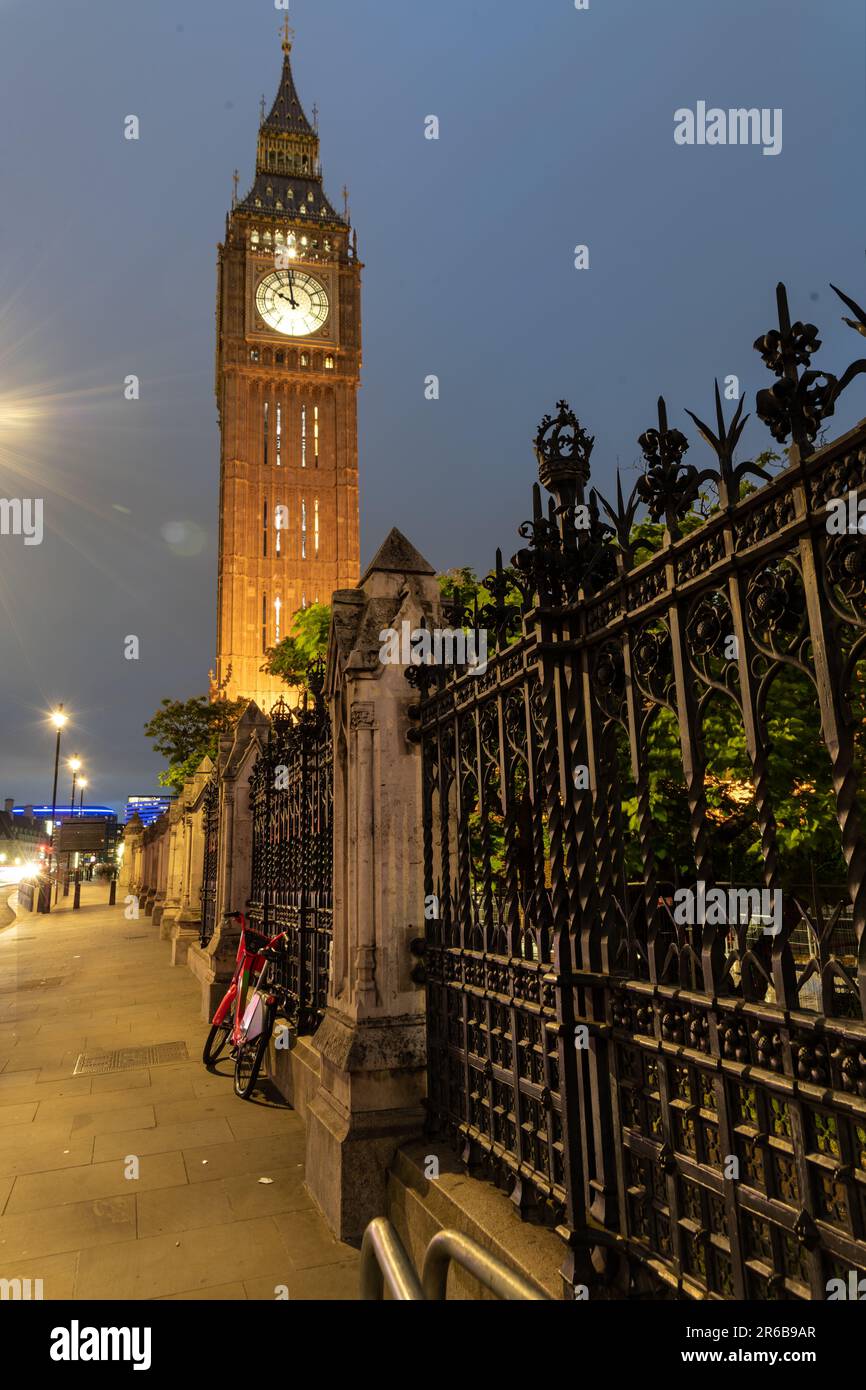 An iconic nighttime view of Big Ben in London, England, illuminated against a dark sky Stock Photo