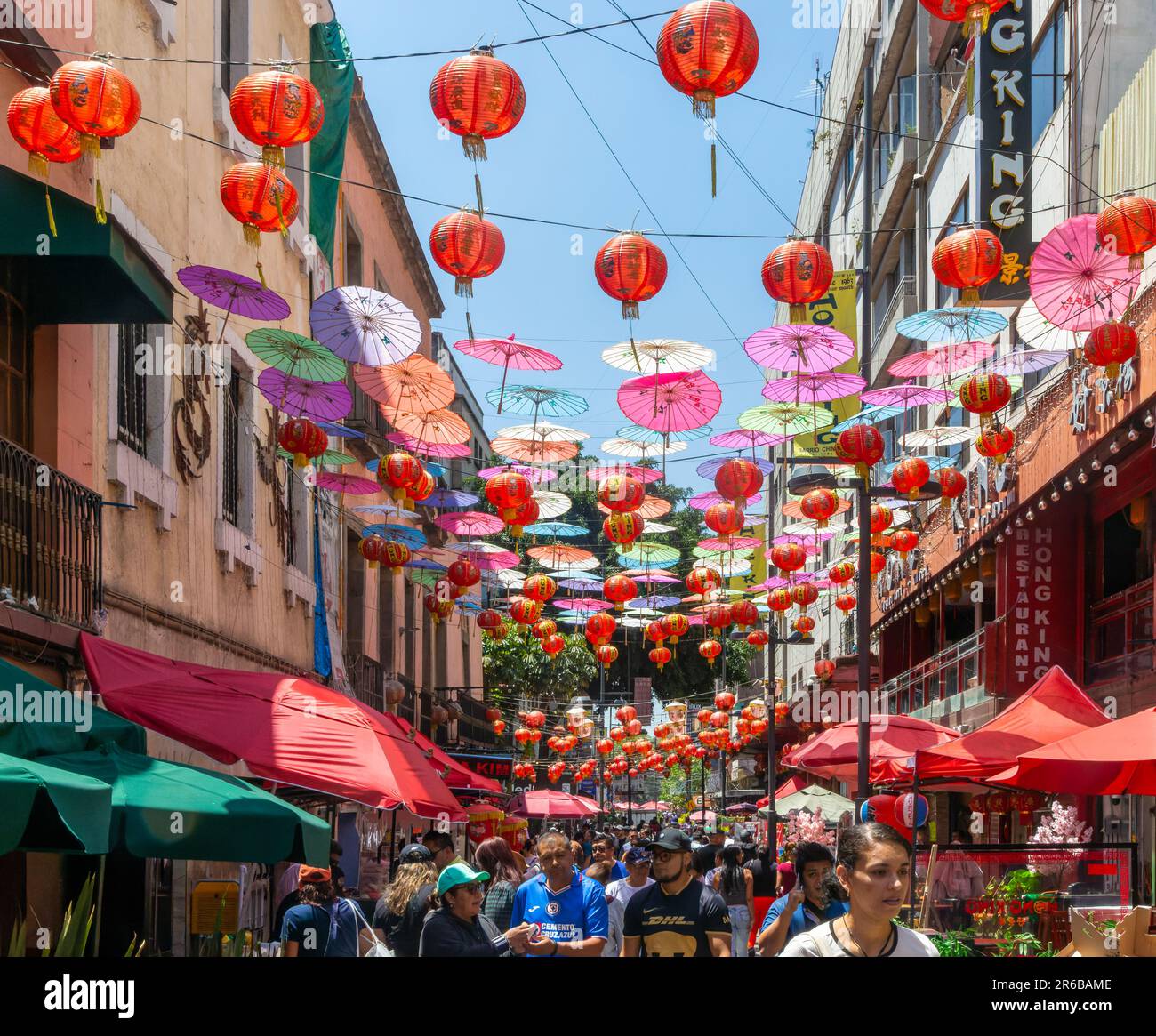 Red paper Chinese lanterns and umbrellas hanging above the