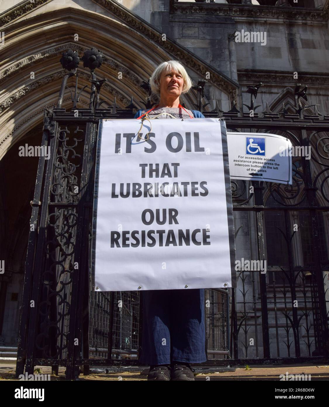 London, UK. 08th June, 2023. A protester holds a placard which states 'It's oil that lubricates our resistance' during the demonstration. Climate protesters gathered outside the Royal Courts of Justice during the judicial review of the planning permission for UK Oil And Gas to explore for fossil fuels near the village of Dunsfold. Credit: SOPA Images Limited/Alamy Live News Stock Photo
