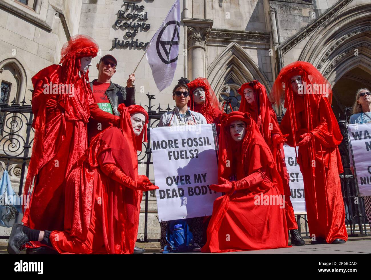 London, UK. 08th June, 2023. Extinction Rebellion protesters wearing red costumes, known as the Red Rebel Brigade, perform during the demonstration. Climate protesters gathered outside the Royal Courts of Justice during the judicial review of the planning permission for UK Oil And Gas to explore for fossil fuels near the village of Dunsfold. Credit: SOPA Images Limited/Alamy Live News Stock Photo