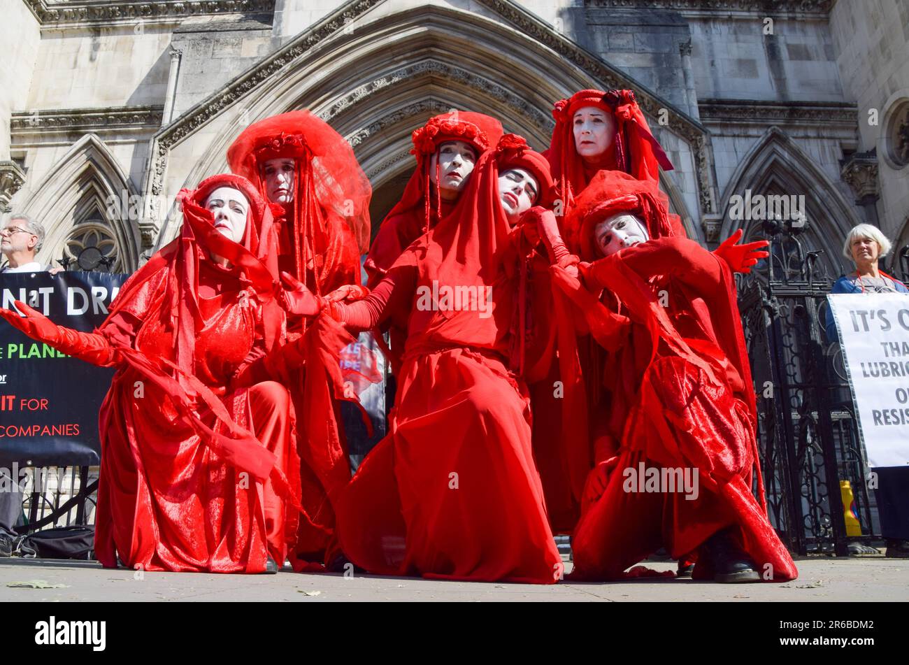 Extinction Rebellion protesters wearing red costumes, known as the Red Rebel Brigade, perform during the demonstration. Climate protesters gathered outside the Royal Courts of Justice during the judicial review of the planning permission for UK Oil And Gas to explore for fossil fuels near the village of Dunsfold. (Photo by Vuk Valcic / SOPA Images/Sipa USA) Stock Photo