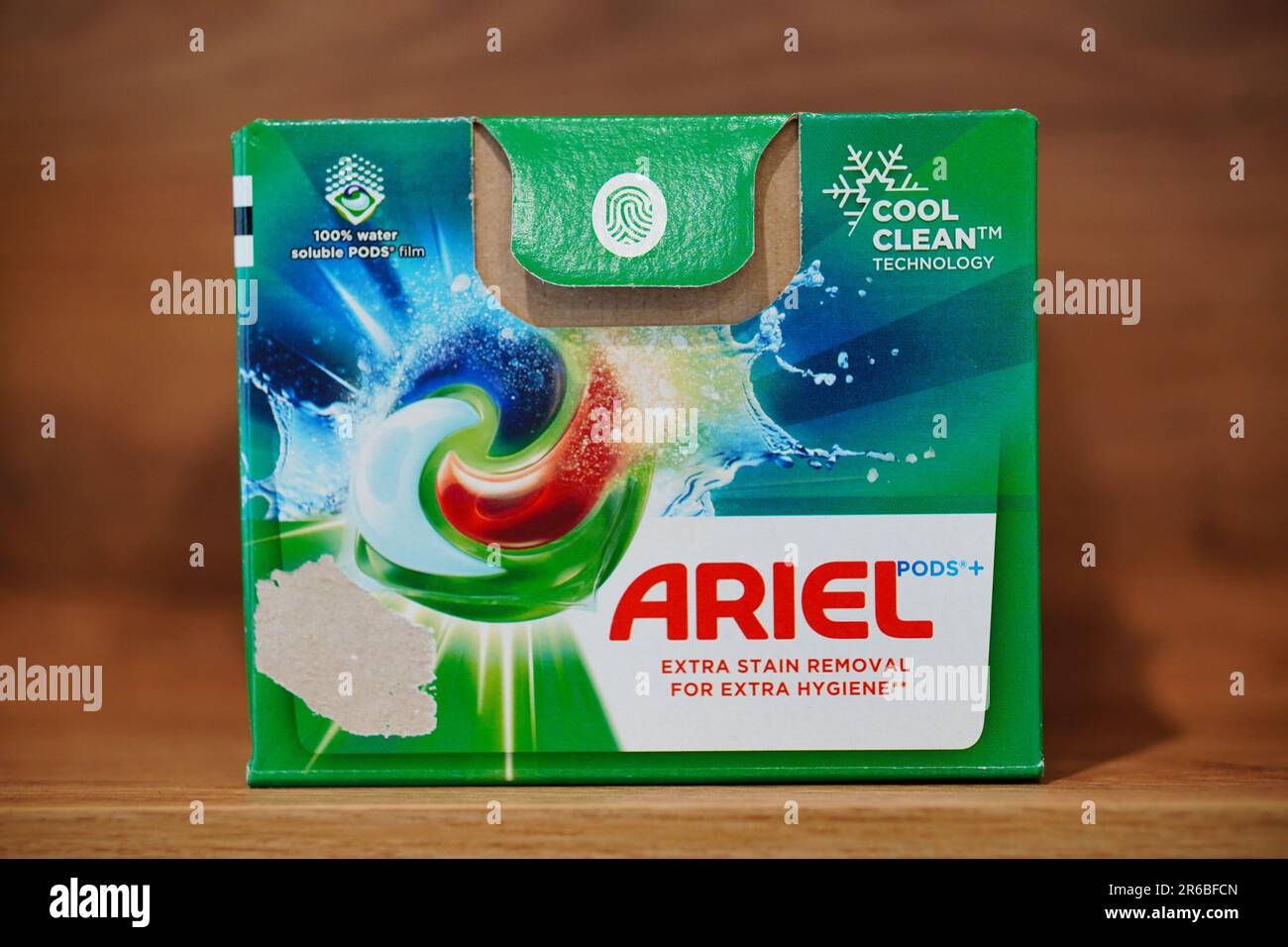 A green cardboard box of washing capsules. Ariel Extra Stain