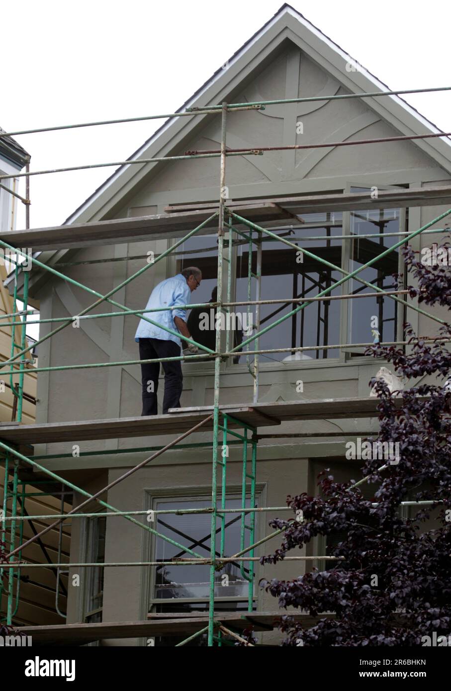 A man renovates the front of a home in San Francisco, Calif. on Friday