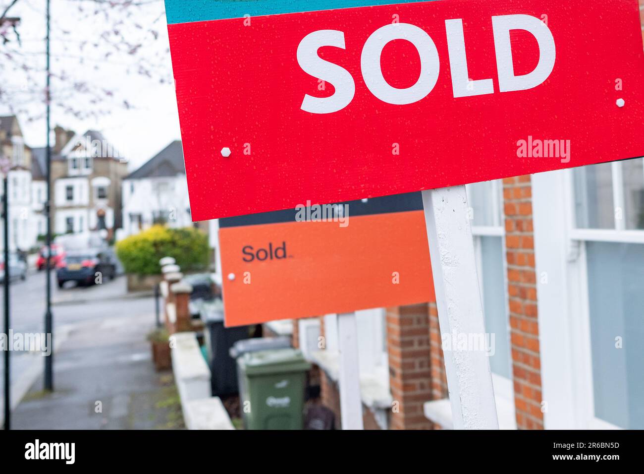 Estate agent 'SOLD' sign on residential street Stock Photo