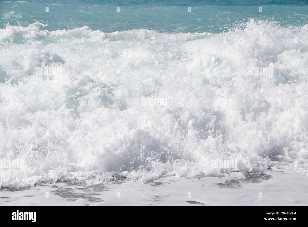 close up of white foamy sea wave on beach in Nice Stock Photo - Alamy