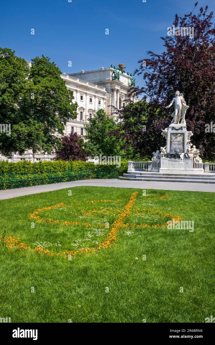 The Mozart Monument in the Burggarten with the Hofburg Palace in the background, Vienna, Austria Stock Photo