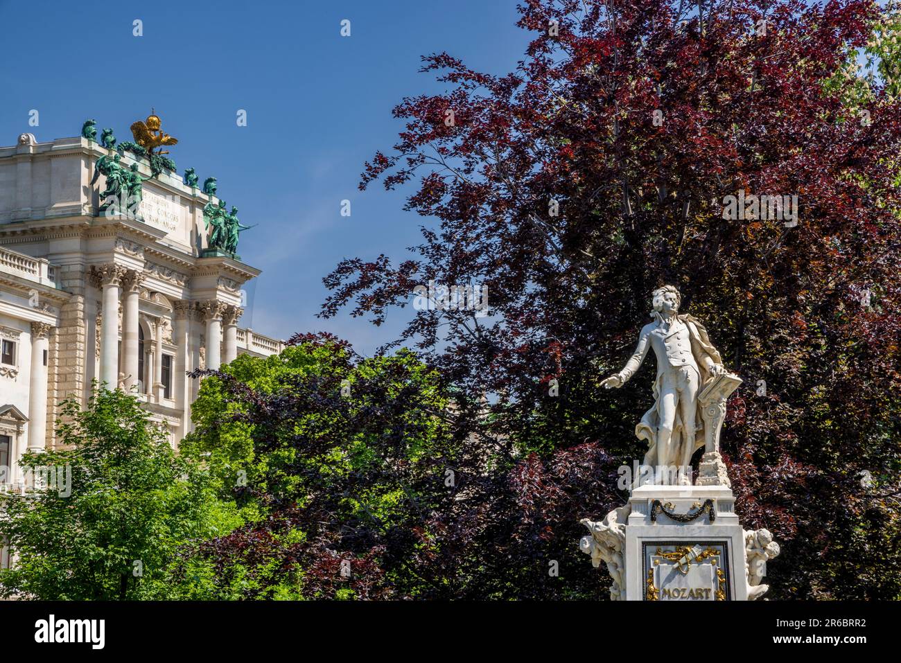 The Mozart Monument in the Burggarten with the Hofburg Palace in the background, Vienna, Austria Stock Photo