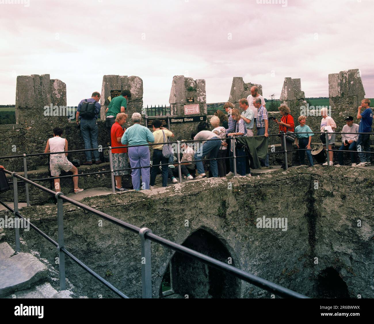 Ireland. County Cork. Blarney Castle. Visitors at kissing the Blarney Stone ceremony. Stock Photo