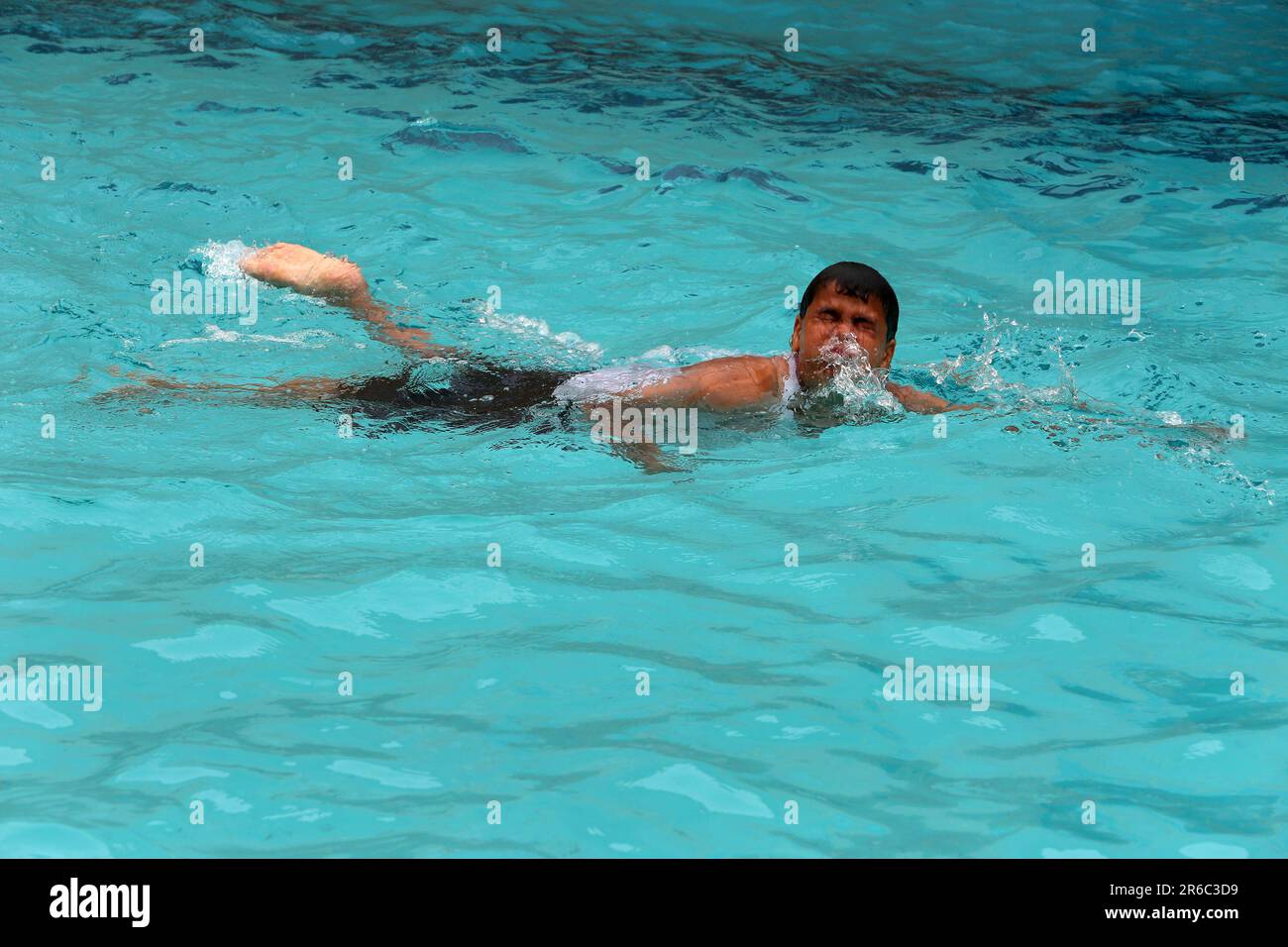 Palestinian children enjoy themselves in a cold water pool during hot