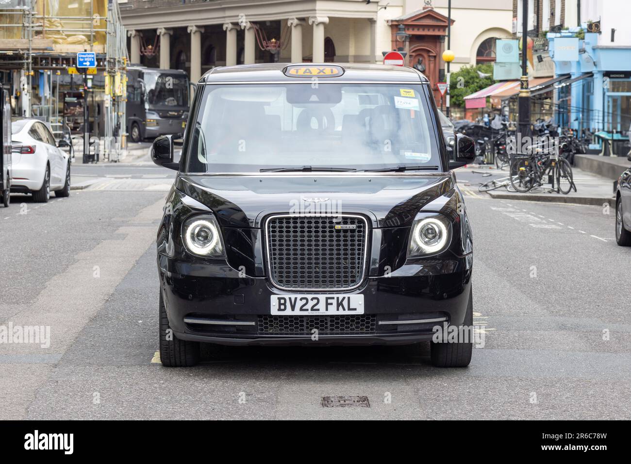 London, UK - May 2023: London taxi stopped by pedestrian walkway on Westminster, London, United Kingdom Stock Photo