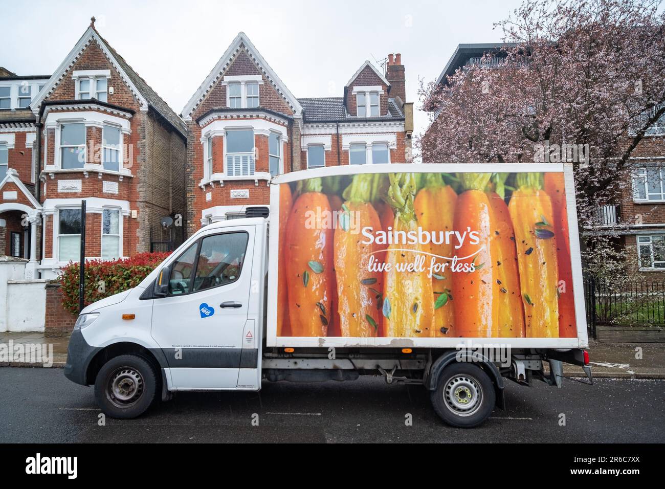 LONDON, MARCH 2023: Sainsburys delivery van on urban street- online delivery service for large British supermarket Stock Photo
