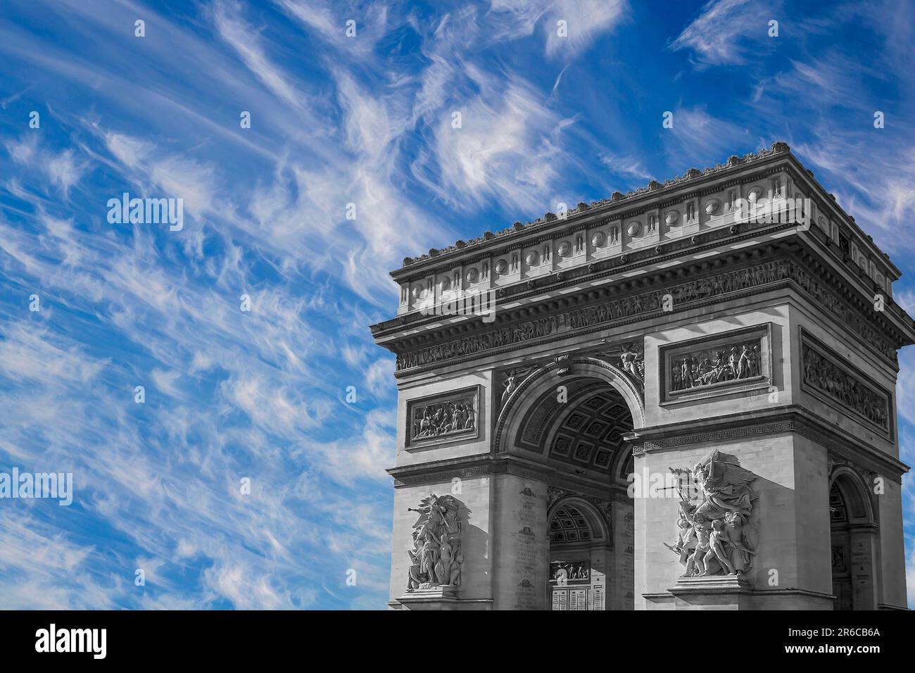 Arc de Triomphe (against the background of sky with clouds), Paris, France.  The walls of the arch are engraved with the names of 128 battles and names  Stock Photo - Alamy