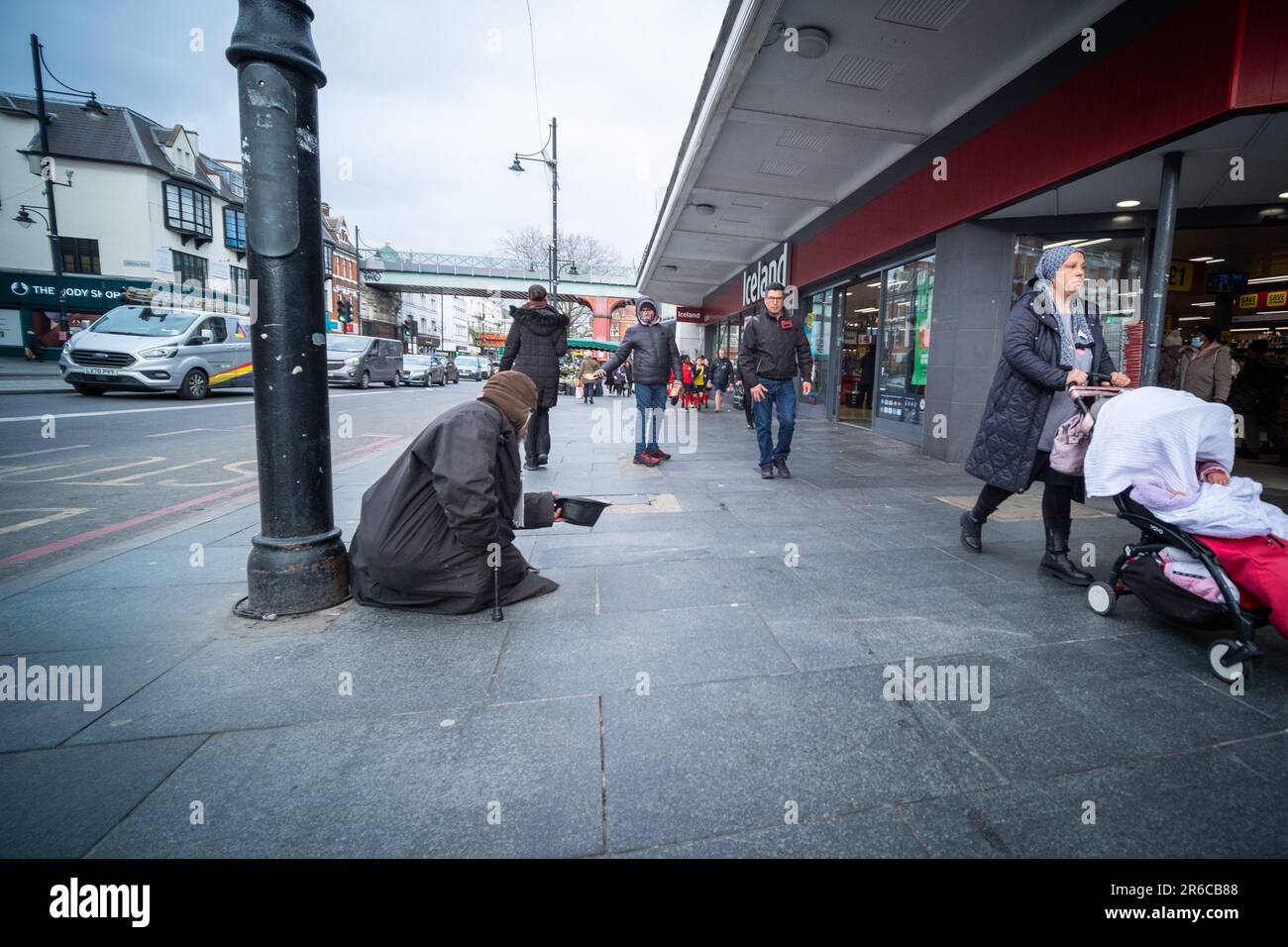 LONDON, MARCH 2023: A homeless man begging on the street of Brixton in south west London Stock Photo