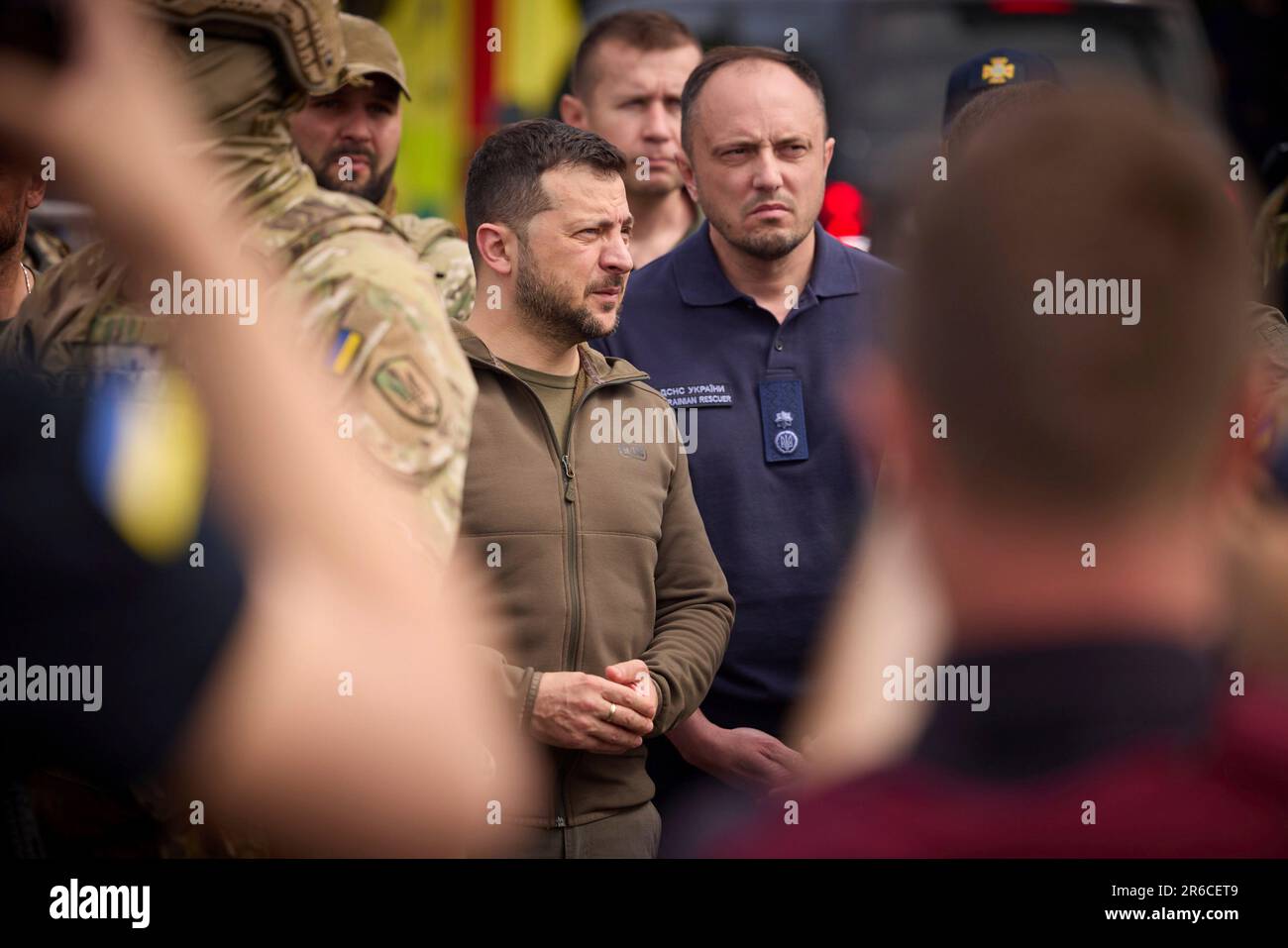 Mykolaiv, Ukraine. 08th June, 2023. Ukrainian President Volodymyr Zelenskyy, left, and State Emergency Service head Serhiy Kruk, right, speak with residents and officials after the sabotaged Kakhovka hydroelectric power plant dam flooded the region, June 8, 2023 in the Kherson region, Ukraine. Credit: Pool Photo/Ukrainian Presidential Press Office/Alamy Live News Stock Photo
