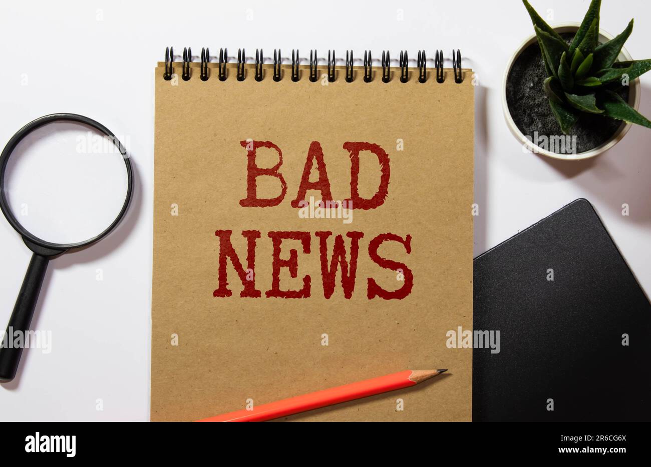 Bad News Title Newspaper on a wooden desk or table. Bad News Message. Top view of a Blank newspaper with Bad News Title. Copy Space for your Text or I Stock Photo