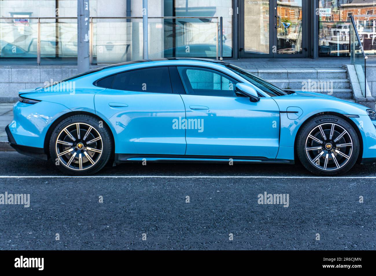 A blue Porsche Taycan 4S electric vehicle parked in Dublin, Ireland. Stock Photo