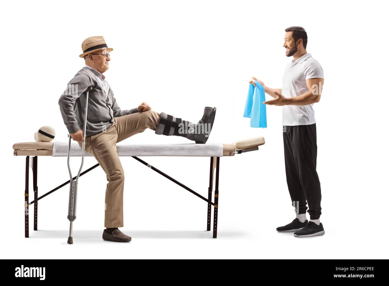 Elderly male patient sitting on a therapy bed with a brace on his leg