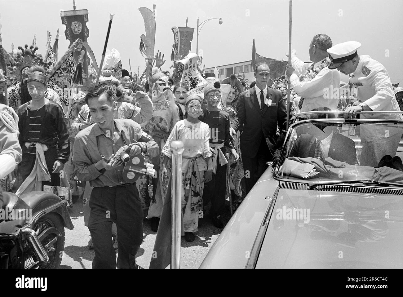 U.S. Vice President Lyndon B. Johnson, standing in a car, as Secret Service agent stands by, saying goodbye to crowds at airport, before leaving Saigon, South Vietnam, Thomas J. O'Halloran,  U.S. News & World Report Magazine Photograph Collection, May 13, 1961 Stock Photo