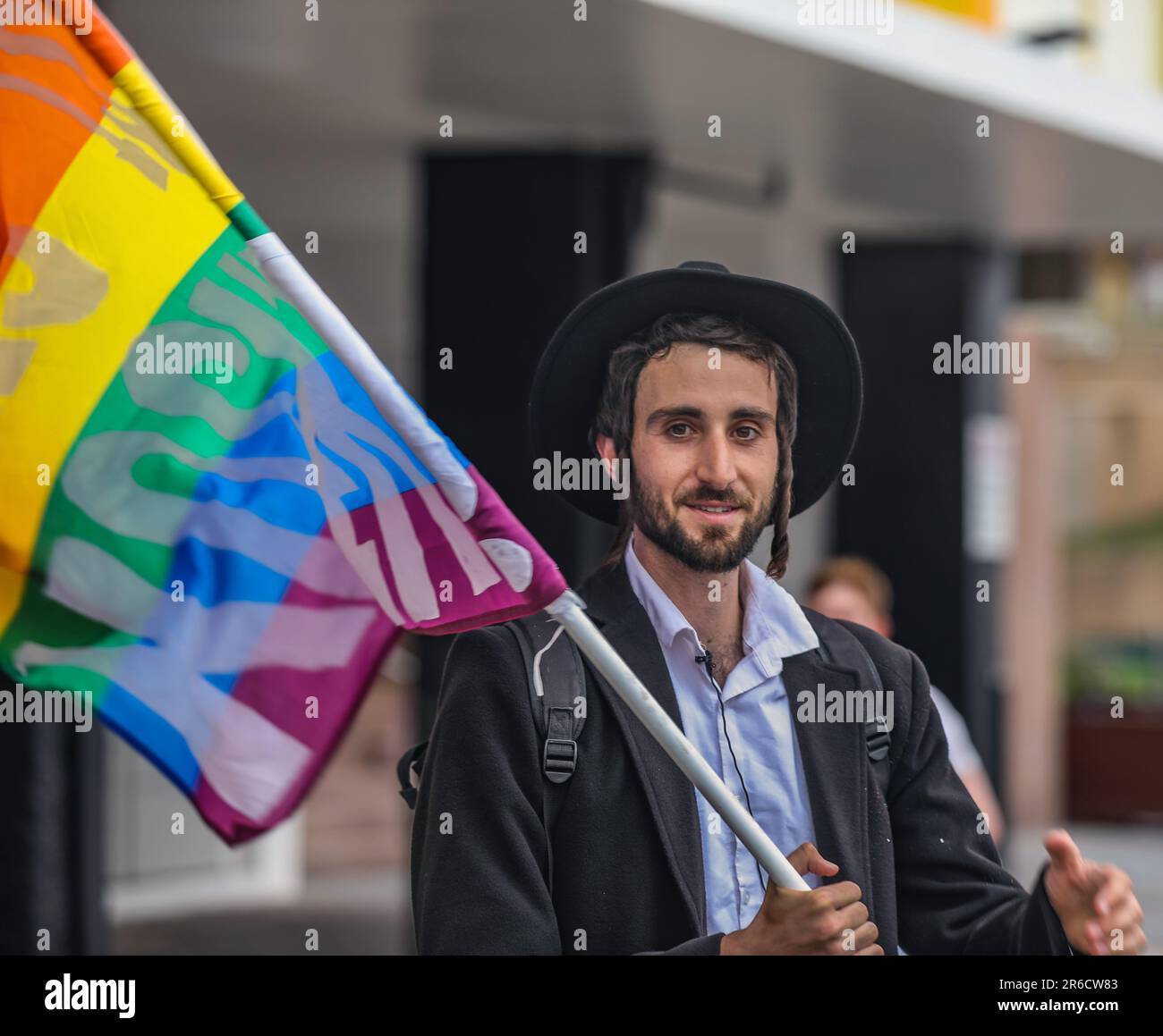 Tel Aviv, Israel. 8th June 2023. An Ultra-Orthodox Jew with a hat and Payot, holding the rainbow flag, at the Tel Aviv pride parade   Credit: Yoram Biberman/Alamy Live News. Stock Photo